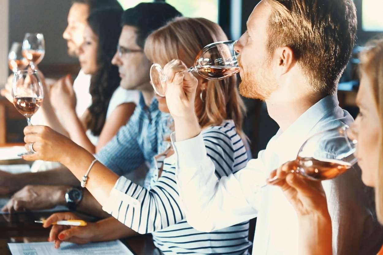 Sich einer Weinbeschreibung bei einer Verkostung nähern: Hier Menschen die Weine probieren.